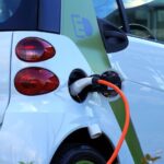 Close-up of an electric car being charged, highlighting eco-friendly transportation.