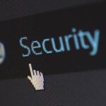 Close-up view of a mouse cursor over digital security text on display.